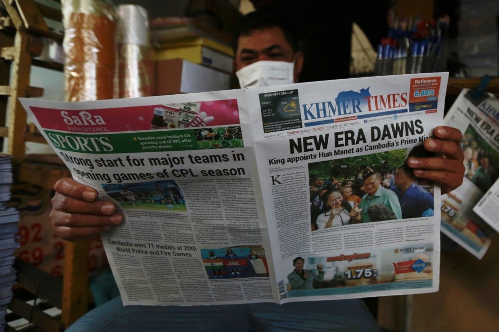 A man reads newspaper at a street in Phnom Penh on Tuesday. Cambodia’s king on Monday appointed army chief Hun Manet, 45, to succeed prime minister Hun Sen, 70. Photo: EPA-EFE