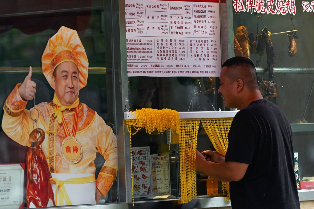 A customer buys food at a Beijing market. Sentiment towards China’s economy has soured in recent months, but there is significant upside potential, given the right kind of policy support from the government. Photo: AFP