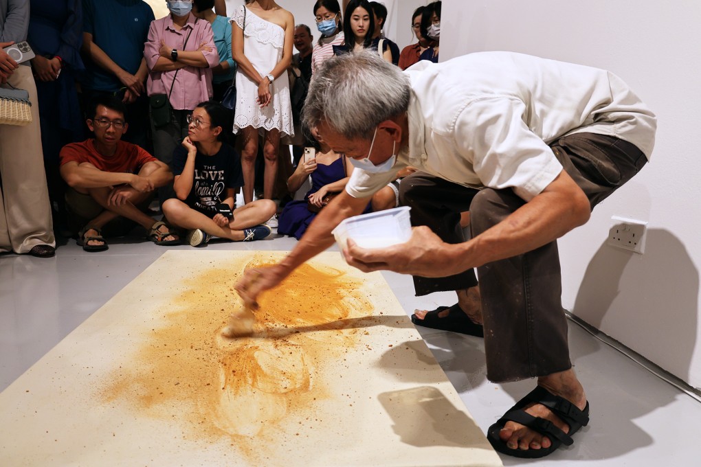 Singaporean artist Tang Da Wu paints with earth at the opening of his solo exhibition “3, 4, 5, I Don’t Like Fine Art” at ShanghART Gallery in Singapore on July 29, 2023. Photo: ShanghART