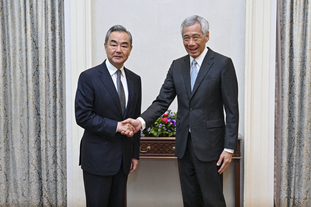Chinese Foreign Minister Wang Yi (left) shakes hands with Singaporean Prime Minister Lee Hsien Loong in Singapore on Friday. Photo: Xinhua