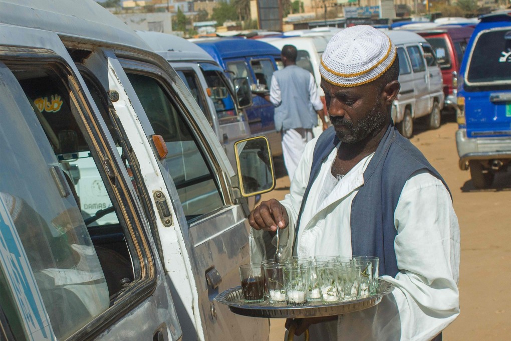 A street vendor sells tea at a bus station in Madani in May. Photo: AFP