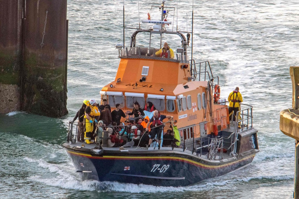 Paramedics help migrants picked up at sea while attempting to cross the English Channel, in Dover, southeast England on Saturday. Six Afghan males died when a migrant boat heading to Britain sank in the Channel early on Saturday. Photo: AFP