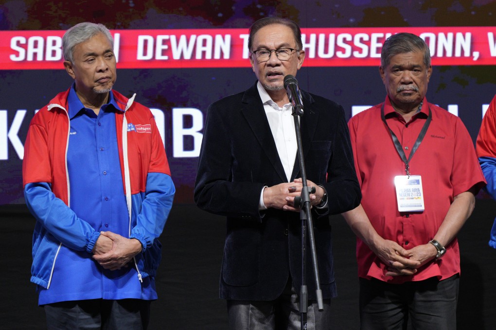 Malaysian Prime Minister Anwar Ibrahim, centre, with other leaders including deputy prime minister Ahmad Zahid Hamidi, left, after announcing the result of the state election at UMNO headquarters in Kuala Lumpur. Photo: AP