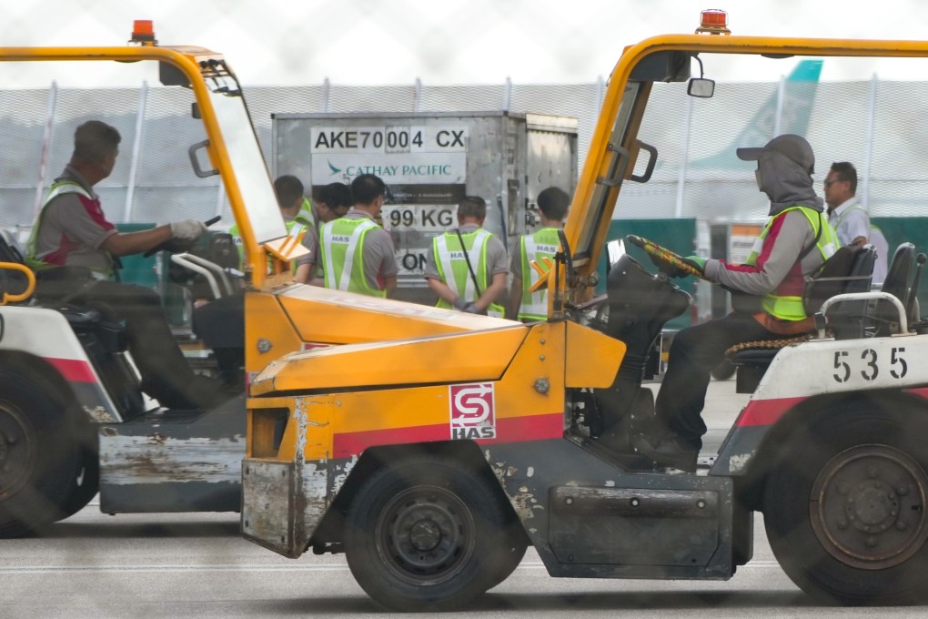 Staff at the airport dealing with aircraft cargo. Photo: Sam Tsang