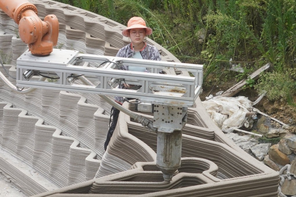 Concrete mixture is pumped through a 3D printer mounted on a robot to build new walls for a traditional rural house in Nanlong village, in China’s Guizhou province, as part of a University of Hong Kong team’s efforts to revitalise structures in the village. Photo: John Lin and Lidia Ratoi