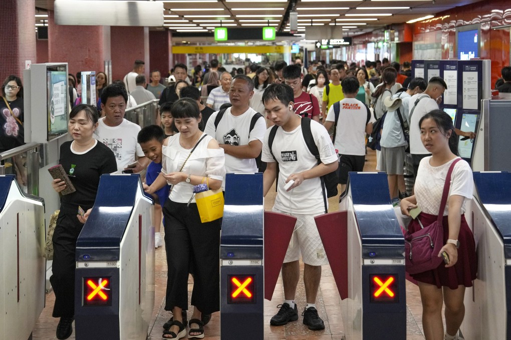 Passengers enter the gates at Mong Kok MTR Station. Photo: Elson Li
