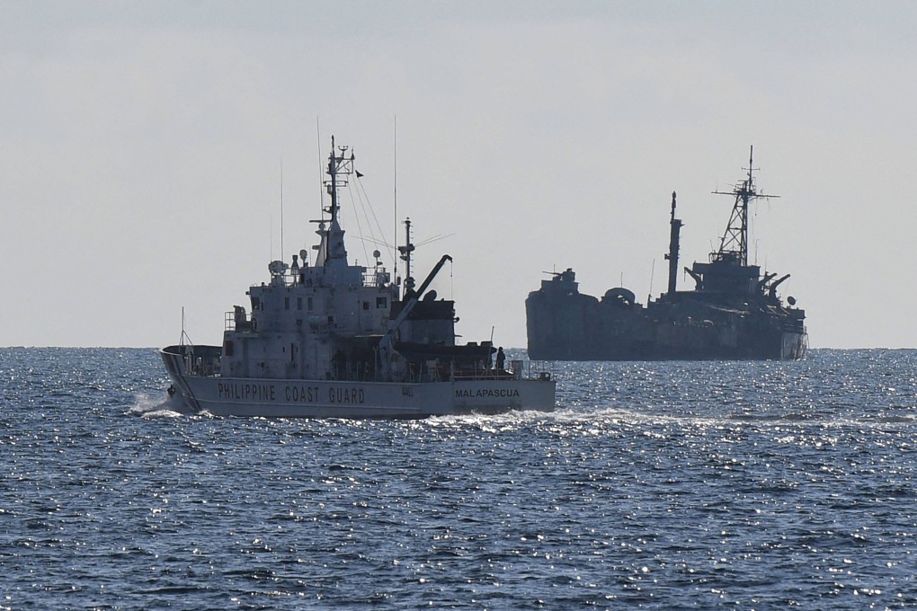A Philippine Coast Guard vessel (left) patrols near the grounded navy ship BRP Sierra Madre at Second Thomas Shoal in the disputed South China Sea in April 2023. Photo: AFP