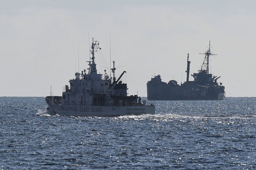 A Philippine Coast Guard vessel (left) patrols near the grounded navy ship BRP Sierra Madre at Second Thomas Shoal in the disputed South China Sea in April 2023. Photo: AFP
