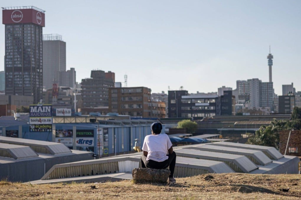A resident looks out towards the skyline of the central business district in Johannesburg, South Africa, on August 15. The Brics summit will take place in the city from August 22-24, with plans to expand the bloc’s membership encountering resistance over concerns about diluting influence and complicating policymaking. Photo: Bloomberg