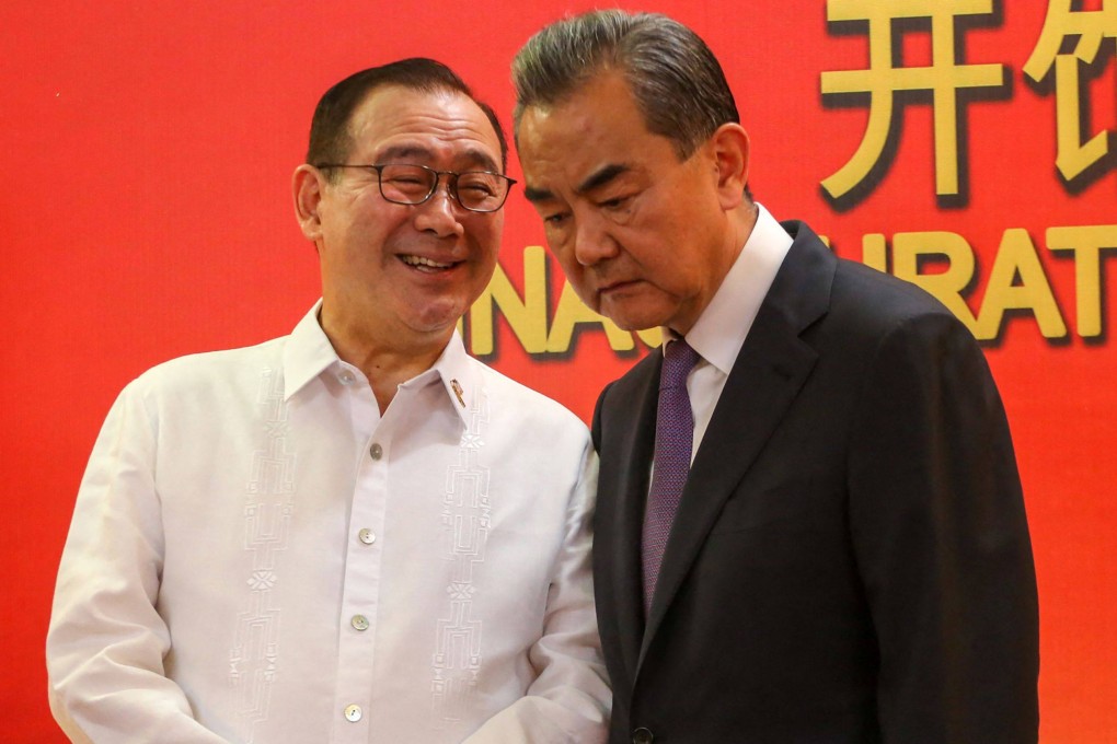 Teodoro Locsin (L), then the Philippines’ foreign minister, talks to China’s Foreign Minister Wang Yi during the inauguration of China’s consulate general in Davao. Photo: AFP