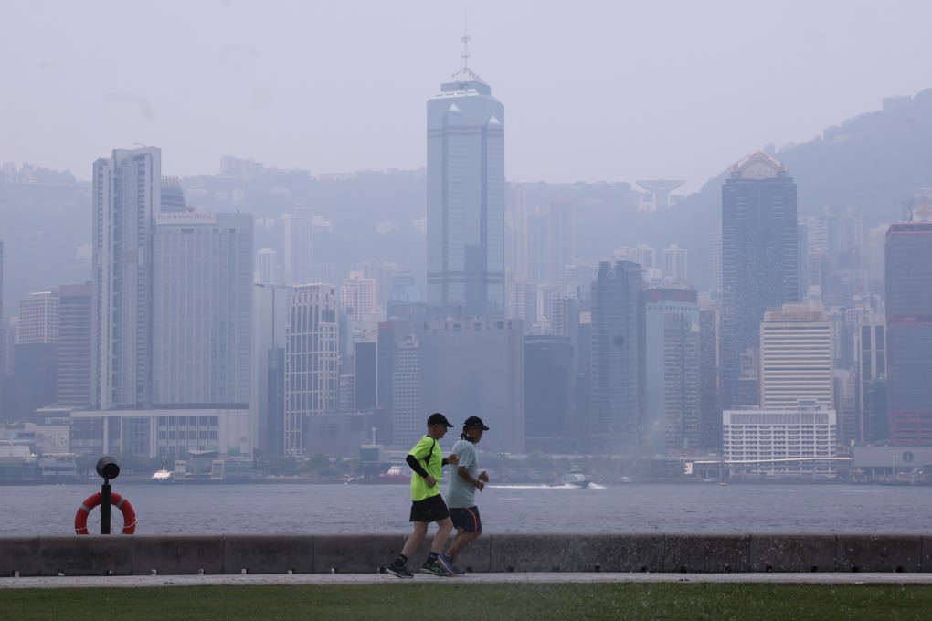 Joggers at the West Kowloon Art Park on July 26, a particularly smoggy day due to a typhoon in the region. Photo: May Tse