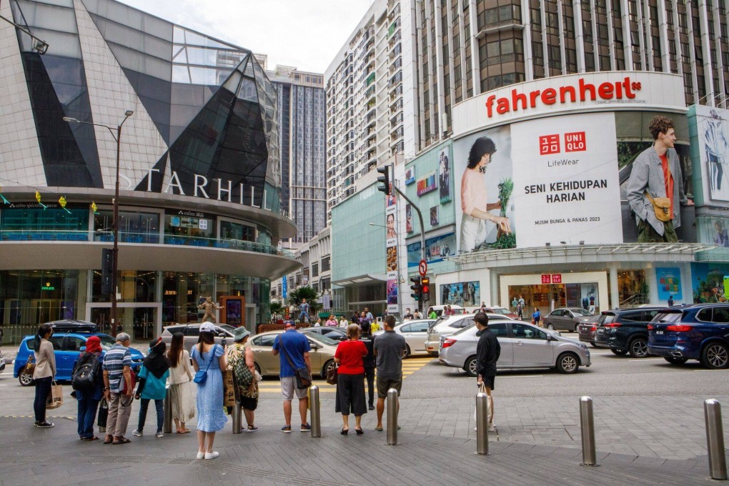 People stand outside Starhill shopping centre in Kuala Lumpur, Malaysia. Photo: Bloomberg