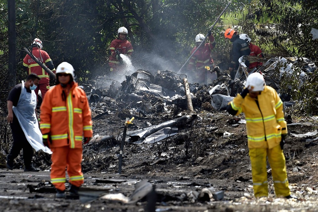 Firefighters try to put out the flames at the scene of a plane crash in Selangor, Malaysia on Thgursday. Photo: Bernama via dpa