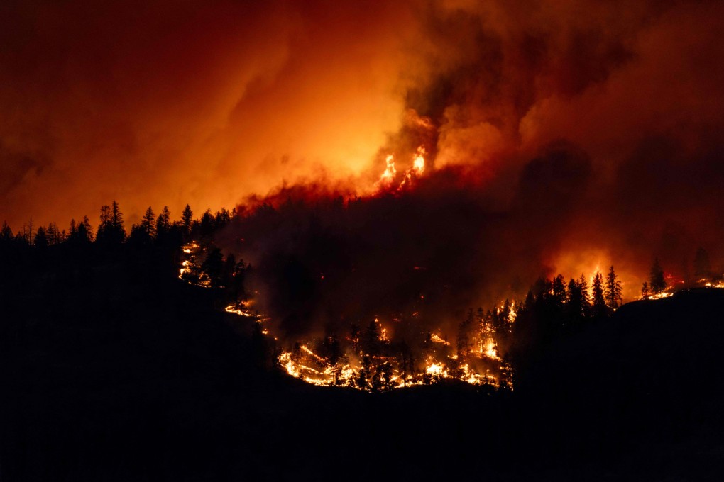 The McDougall Creek wildfire burns in the hills of West Kelowna, British Columbia, Canada on Thursday. Photo: AFP