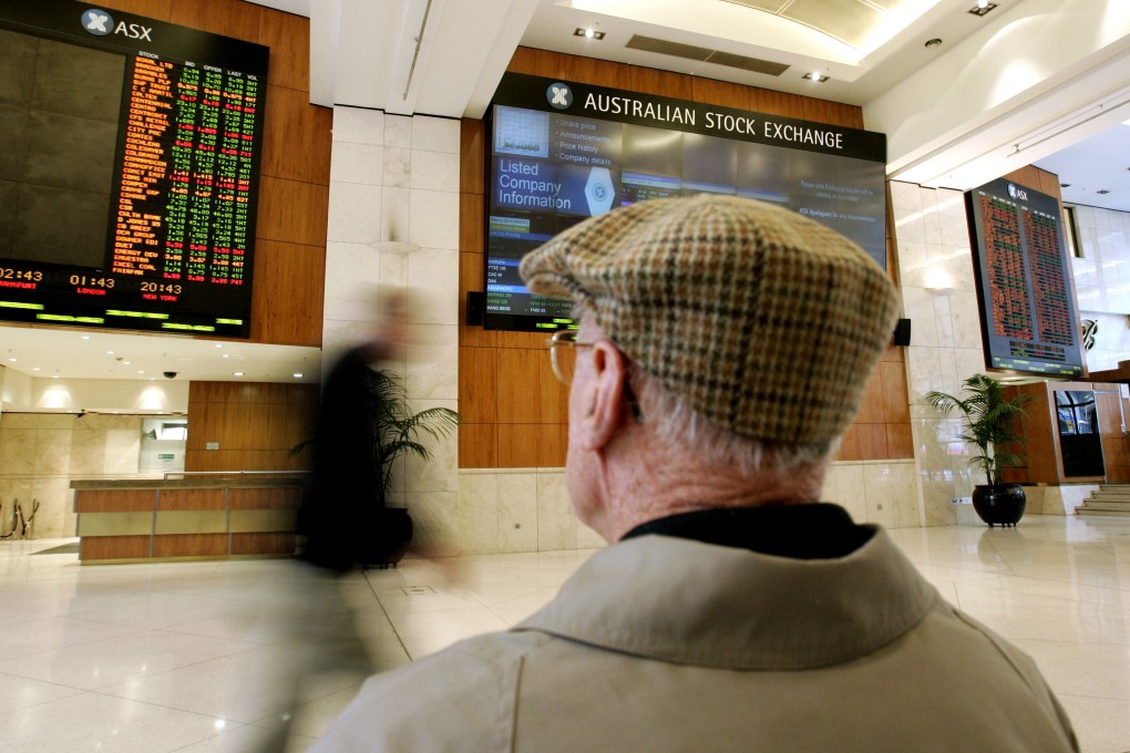 An elderly man looks at Australian Stock Exchange Ltd. boards in Sydney. The number of elderly citizens in Australia is forecast to swell, while overall population growth slows. Photo: AP