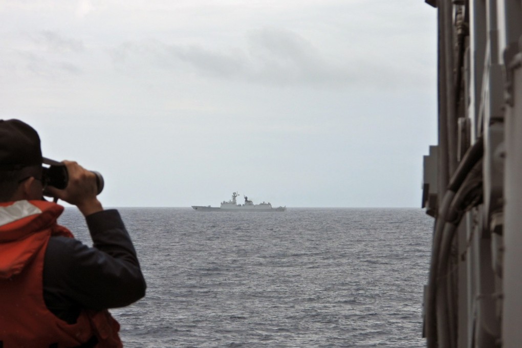 A Taiwanese sailor on the Tian Dan guided-missile frigate monitors the  activities of the PLA’s Xuzhou frigate near Taiwan on Saturday. Photo: EPA-EFE/Taiwan Navy