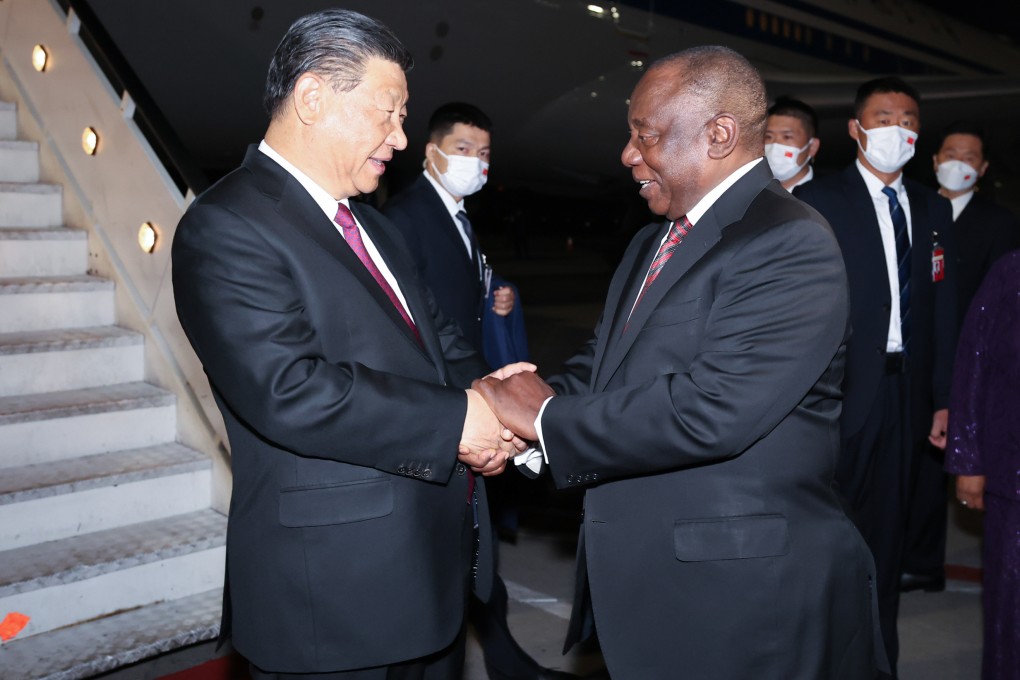 Chinese President Xi Jinping is greeted by South African leader Cyril Ramaphosa at the OR Tambo International Airport in Johannesburg on Monday. Photo: Xinhua