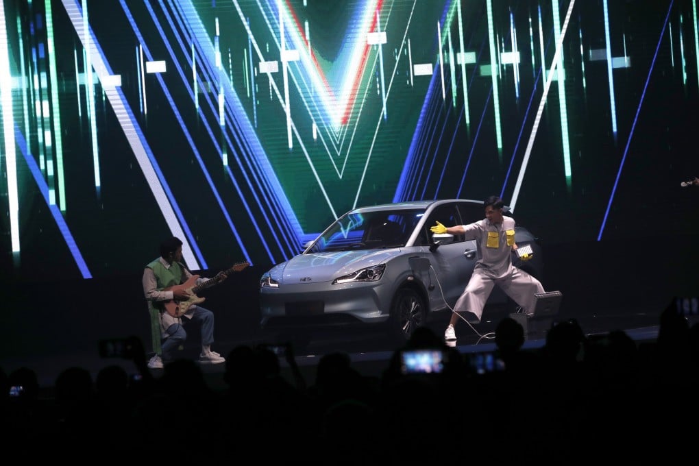 Performers present a Chinese-made smart electric car Hozon NETA V during a launching ceremony event in Bangkok, Thailand. Photo: EPA-EFE
