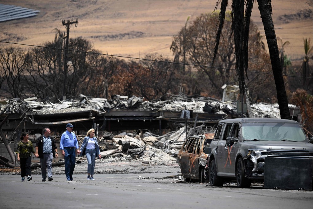 US President Joe Biden (second right), US first lady Jill Biden (right), Hawaii Governor Josh Green (second left) and Jaime Green, first lady of Hawaii, visit an area devastated by wildfires in Lahaina on Monday. Photo: AFP