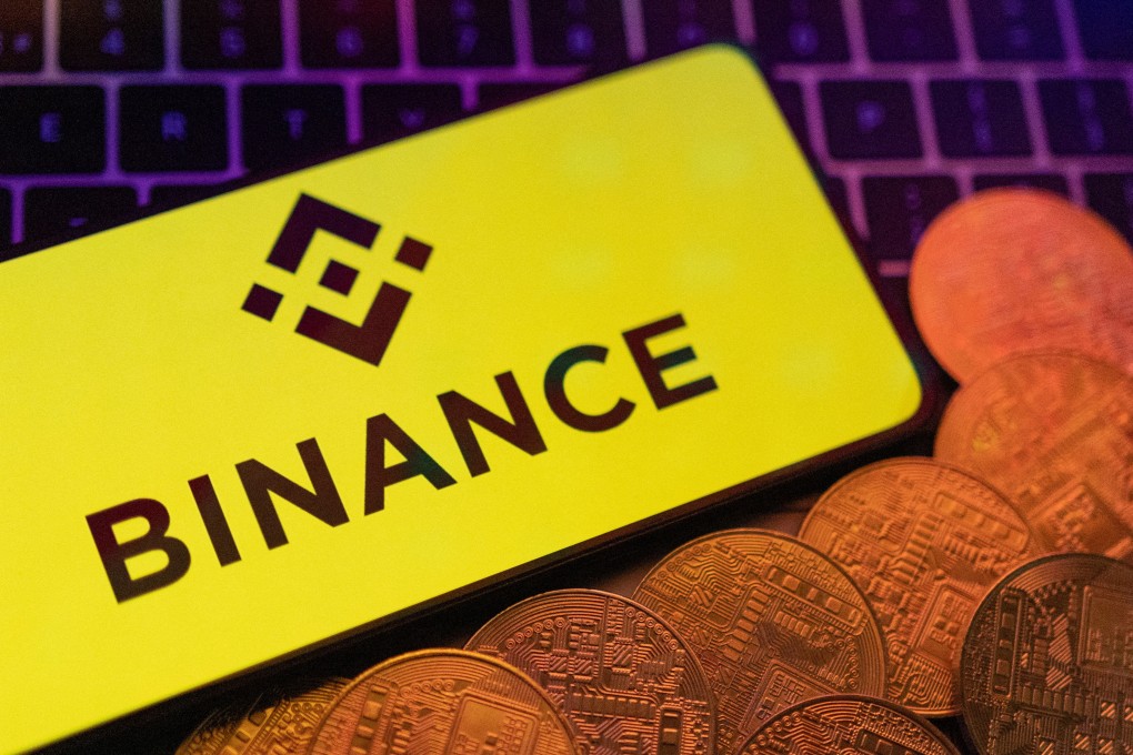 The Binance logo seen on a smartphone next to representation of cryptocurrencies on a keyboard in this illustration taken June 8, 2023. Photo: Reuters