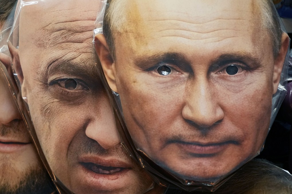 Face masks depicting Russian President Vladimir Putin (right) and owner of private military company Wagner Group Yevgeny Prigozhin are displayed for sale at a souvenir shop in St Petersburg in June. Photo: AP