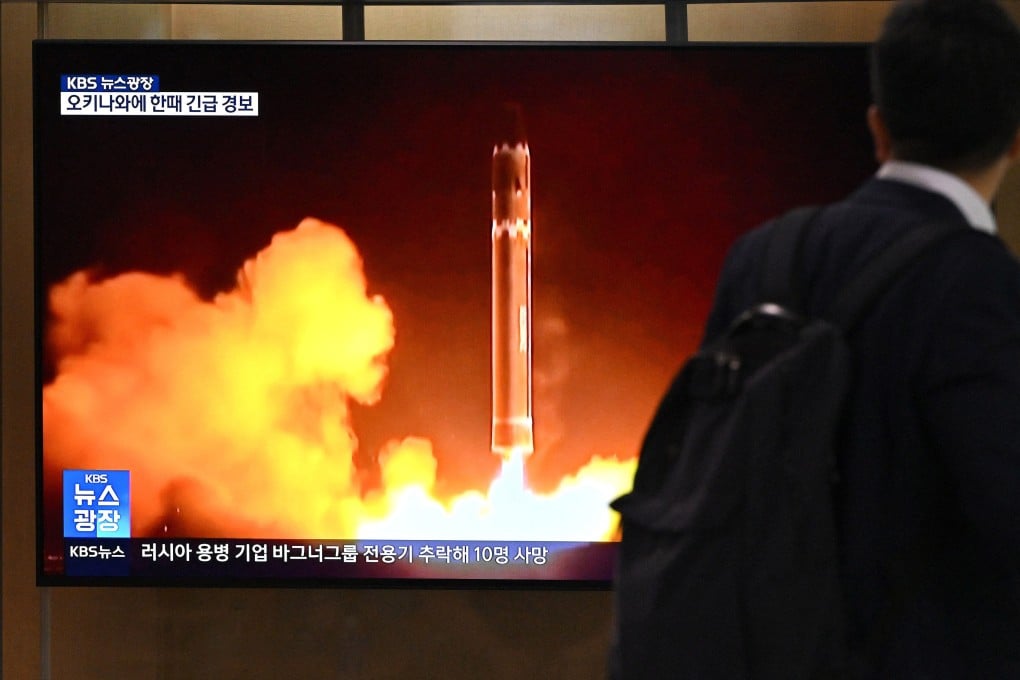 A man walks past a television screen showing a news broadcast with file footage of a North Korean missile test, at a railway station in Seoul on Thursday. Photo: AFP
