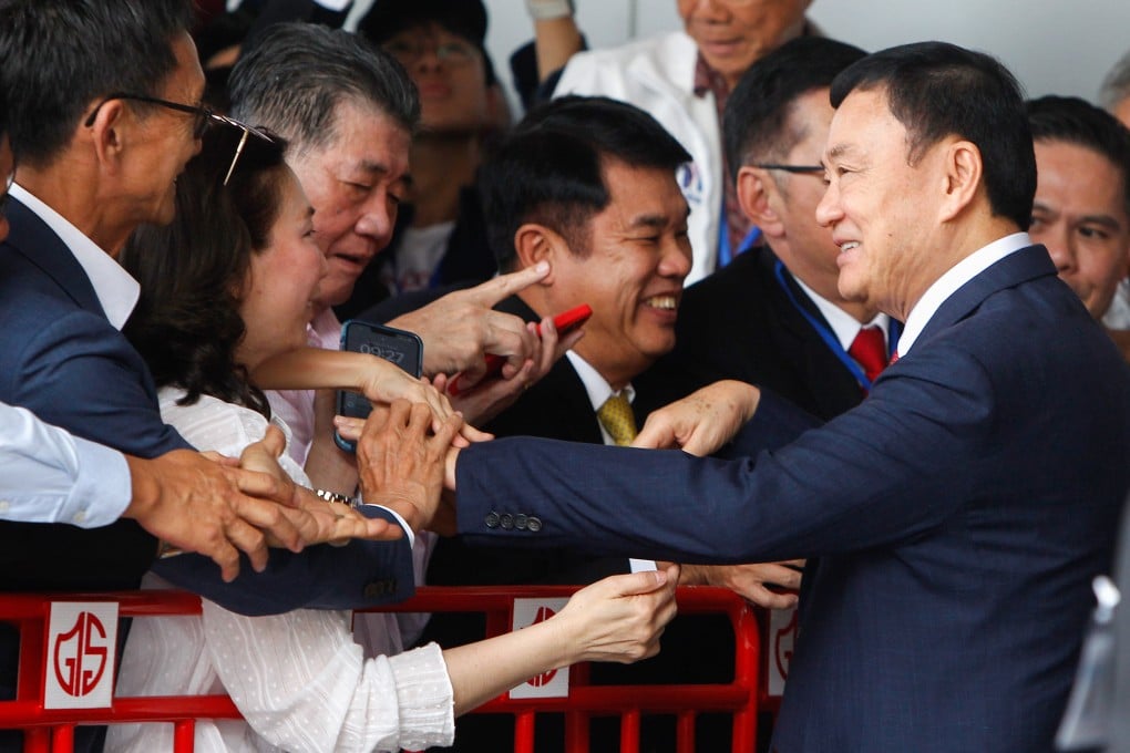 Former Thai prime minister Thaksin Shinawatra greets his supporters as he arrives at Don Mueang airport on Tuesday. Photo: Zuma Press Wire/dpa