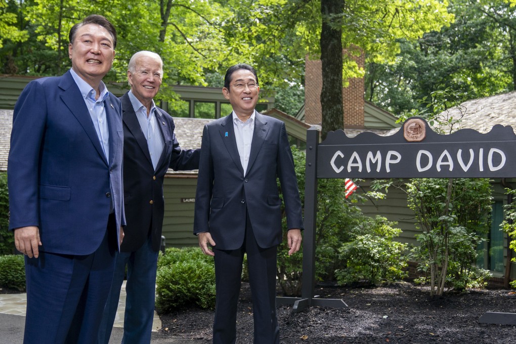 US President Joe Biden (centre) greets South Korean President Yoon Suk-yeol (left) and Japanese Prime Minister Fumio Kishida at Camp David, the presidential retreat, on August 18. Photo: AP