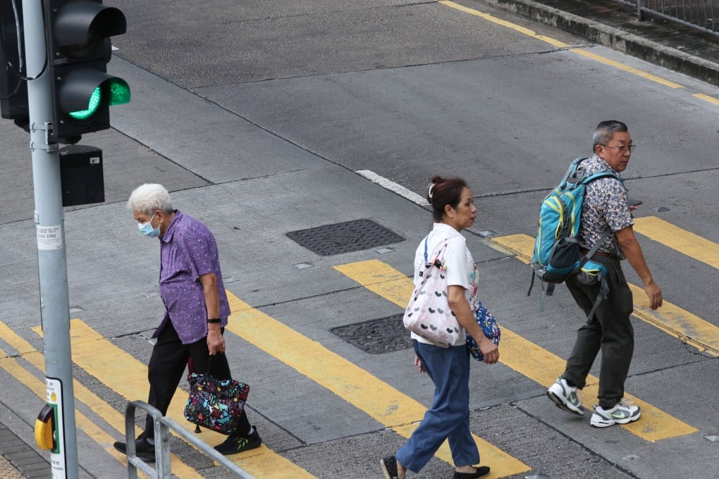 Pedestrians crossing the road when the red pedestrian light is lit at Lok Fu. The city’s police force will step up enforcement action against unsafe behavior by pedestrians and drivers from August 14. Photo: SCMP/ Yik Yeung-man