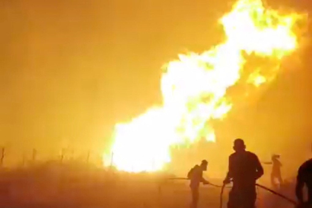 Volunteer firefighters work to douse a wildfire in Greece on Wednesday in this image taken from a social media video. Photo: George Koutsikos via Reuters
