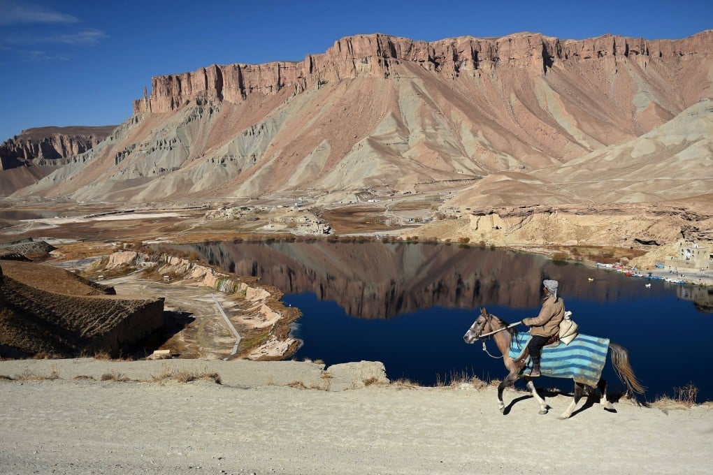 A man rides a horse by a lake in Band-e-Amir, the first national park in Afghanistan. File photo: AFP