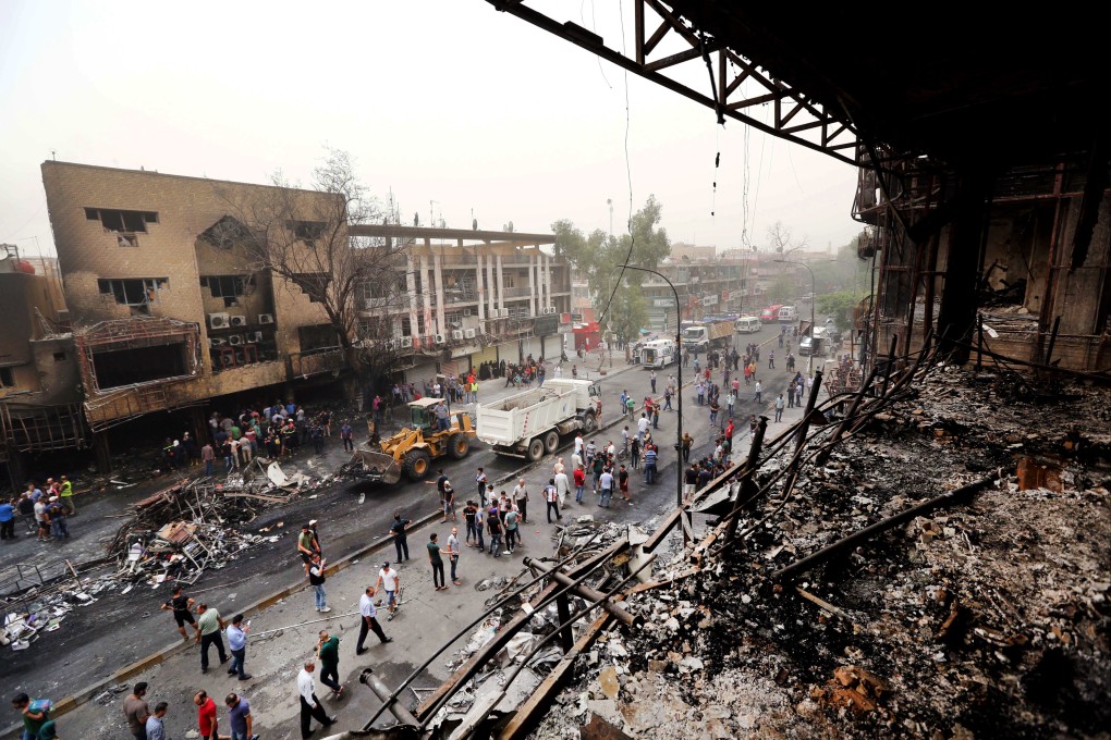 Security forces and civilians gather at the site after a car bomb hit Karada, a busy shopping district in the centre of Baghdad, Iraq on July 3, 2016. Photo: AP