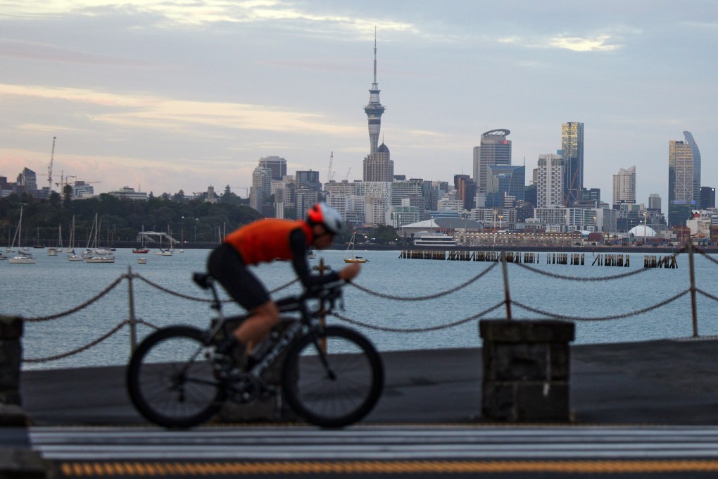 A cyclist rides past Auckland’s skyline. The country’s defence policy and strategy statement said “New Zealand is facing a more challenging strategic environment than it has in decades”. Photo: Bloomberg