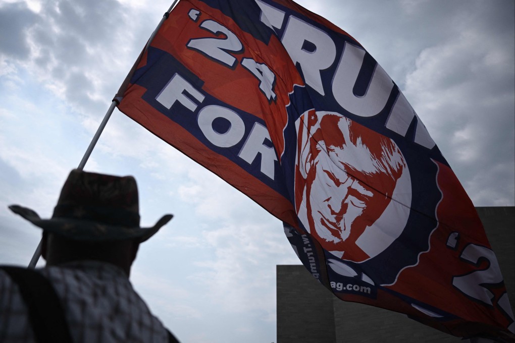 A Donald Trump supporter flies a flag outside the E. Barrett Prettyman US Courthouse in Washington. Photo: AFP
