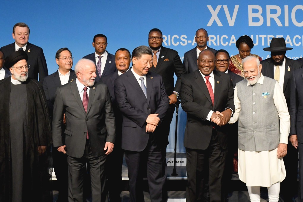 South African President Cyril Ramaphosa (centre) shakes hands with Indian Prime Minister Narendra Modi while (from left) Iranian President Ebrahim Raisi, Brazilian President Luiz Inácio Lula da Silva and Chinese President Xi Jinping look on as they pose for photo with delegates on the closing day of the Brics Summit in Johannesburg, South Africa, on August 24. Photo: EPA-EFE