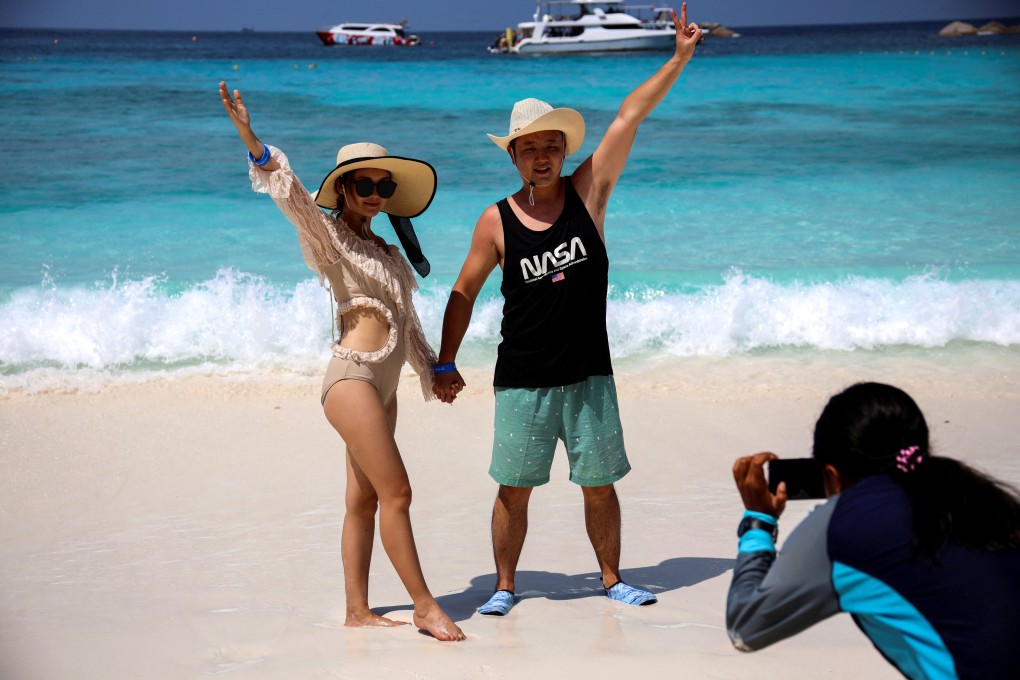 Chinese tourists pose for a photograph on a beach in Thailand’s Phang-Nga province in early 2020, before pandemic-era restrictions brought a halt to most international travel. Photo: Reuters