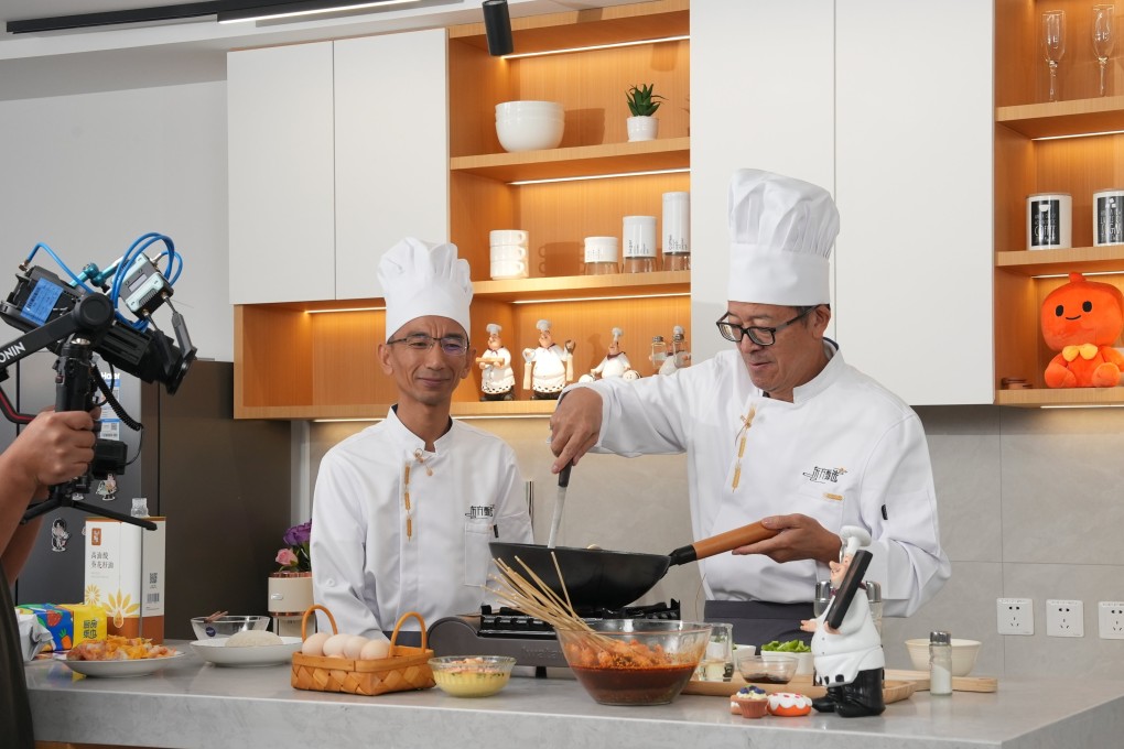 Yu Minhong (right), founder and chairman of New Oriental Education, cooks during a live stream on Taobao. Photo: Handout