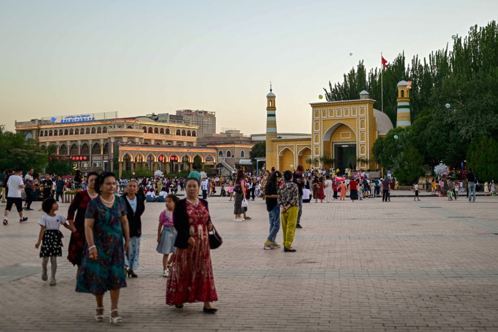 Uygur people outside the Id Kah Mosque in Kashgar, in China’s western Xinjiang region.  Photo: AFP