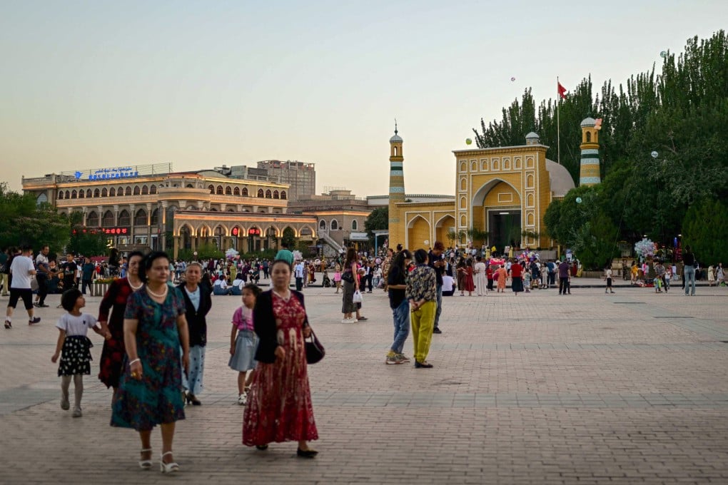 Uygur people outside the Id Kah Mosque in Kashgar, in China’s western Xinjiang region. Photo: AFP