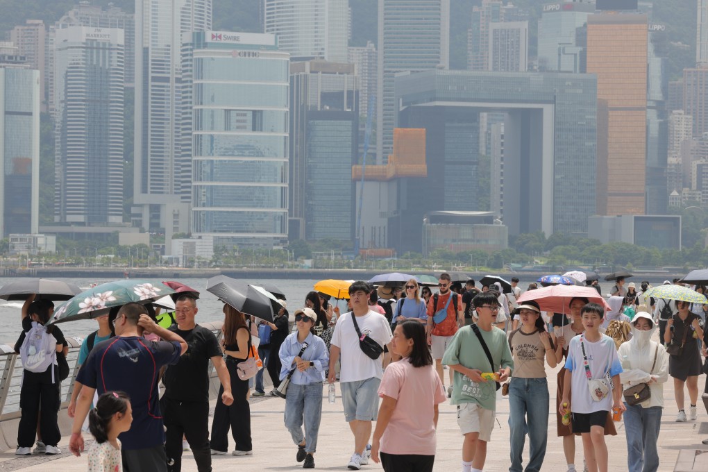 Tourists walk along the waterfront in Tsim Sha Tsui. 10 million travellers from mainland China visited Hong Kong in the first half, pushing up insurance sales. Photo: Jelly Tse