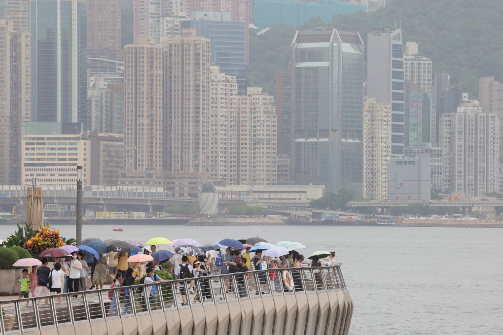 Tourists walk along the waterfront in Tsim Sha Tsui on August 11. Photo: Jelly Tse