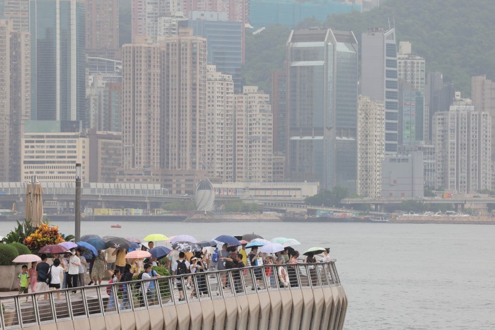 Tourists walk along the waterfront in Tsim Sha Tsui on August 11. Photo: Jelly Tse