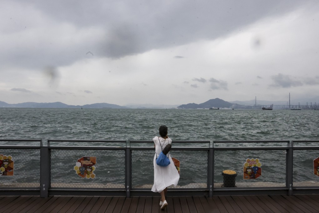 A resident watches the water rise near Belcher Bay Promenade in Kennedy Town as Super Typhoon Saola approaches Hong Kong. Photo: Jonathan Wong