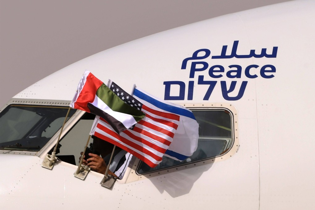 The Emirati, Israeli and US flags fly on an El Al plane, adorned with the word “peace” in Arabic, English and Hebrew, which arrived at Abu Dhabi airport on August 31, 2020. Photo: AFP