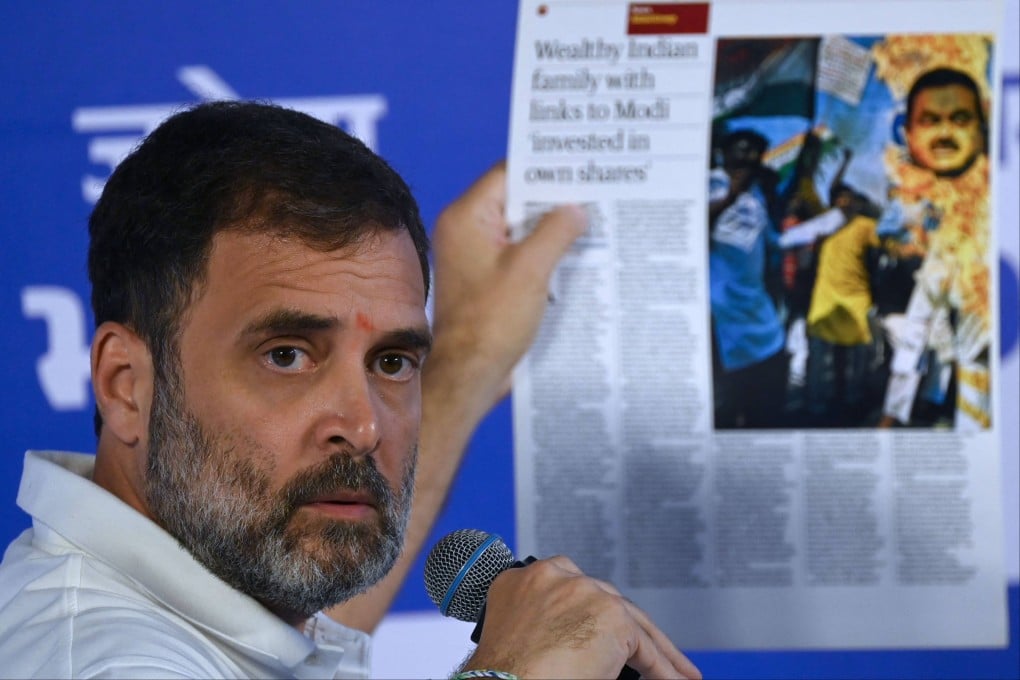 India’s Congress Party leader Rahul Gandhi holds a printout of a report on Gautam Adani in Mumbai on August 31. Photo: AFP