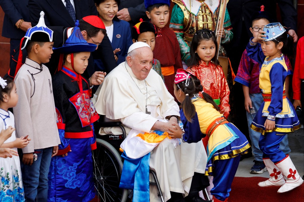 Pope Francis greets a child during a welcoming ceremony in Ulaanbaatar, Mongolia. Photo: Reuters