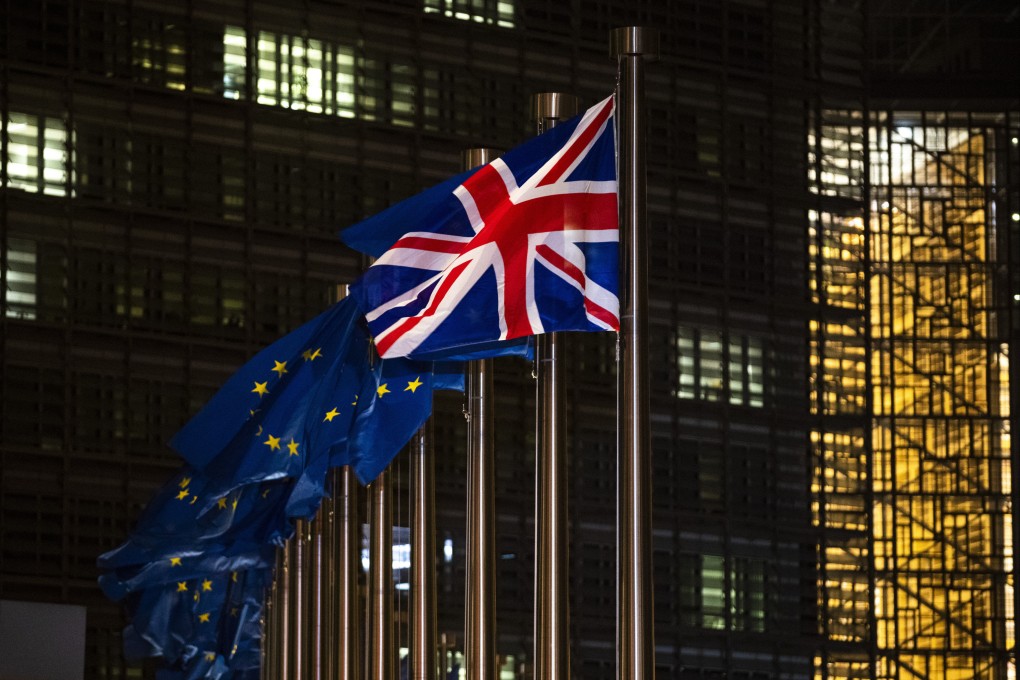 Britain’s national flag and European Union flags flap in the wind at EU headquarters in Brussels. Photo: AP