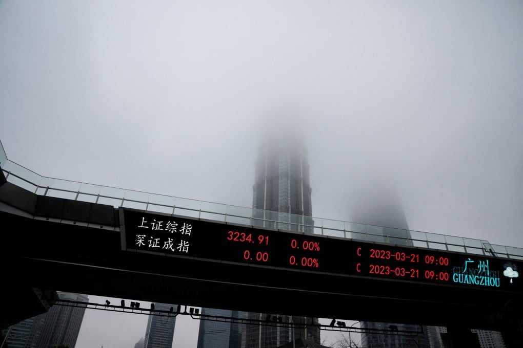 An electronic board shows stock indexes at the Lujiazui financial district in Shanghai on March 21. Photo: Reuters