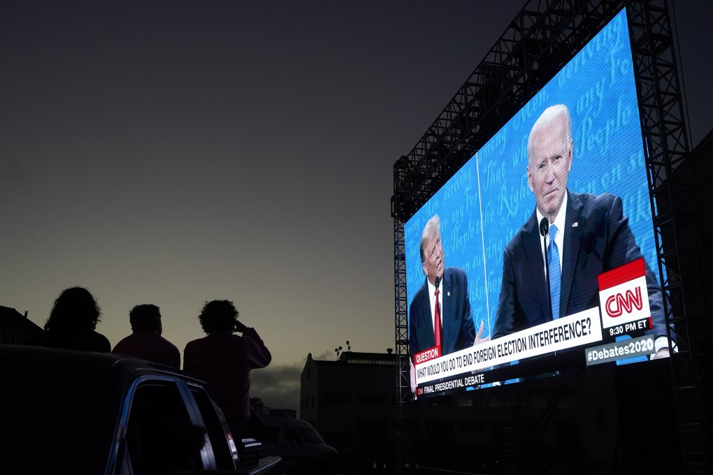 People watch from a vehicle as then-US president Donald Trump and candidate Joe Biden speak during a presidential debate watch party, at Fort Mason Centre in San Francisco, on October 22, 2020. Though the prospect does not appear popular among US voters, the 2024 election seems likely to come down to a rematch between the two. Photo: AP