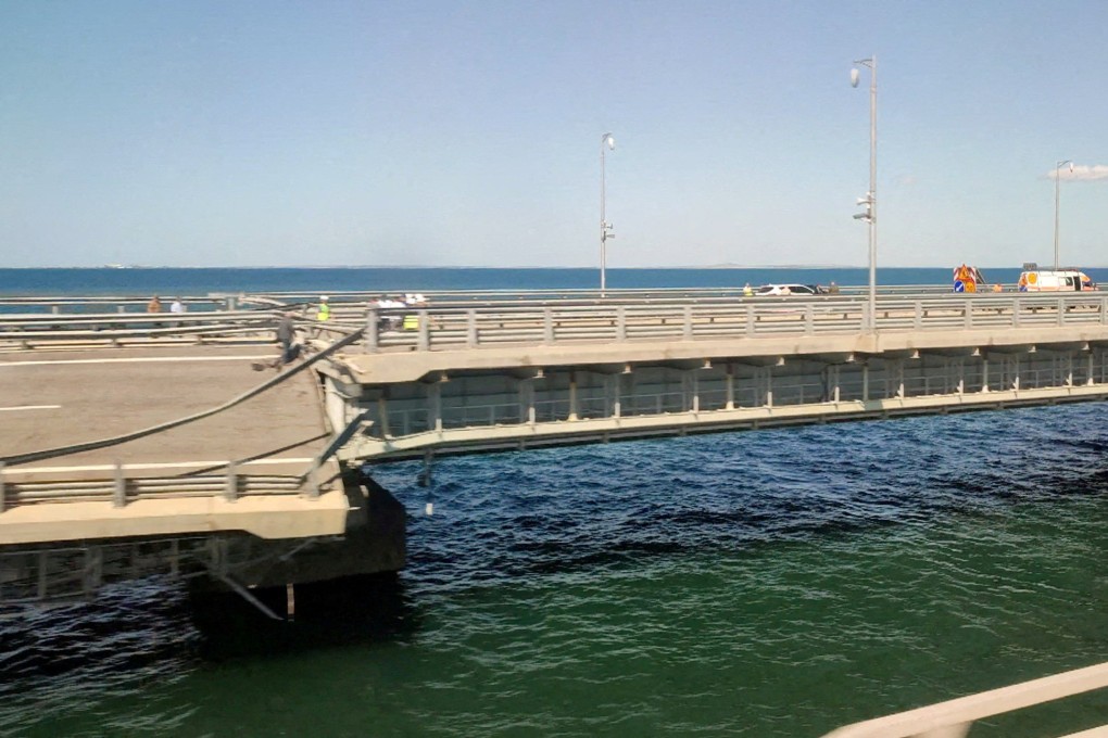 A section of a road is seen split and sloping to one side following an attack on the bridge that connects the Russian mainland with the Crimean peninsula across the Kerch Strait in July. Photo: Reuters